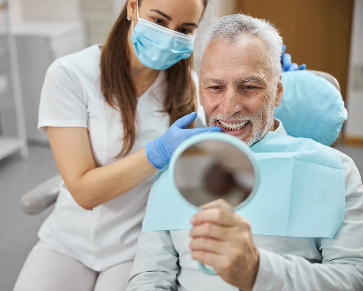 Dental professional reviewing jaw imaging with a patient to discuss implant candidacy options