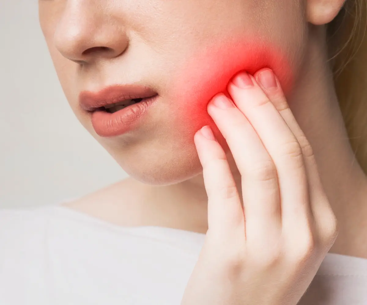 Dental professional assessing a patient with a knocked-out tooth during an emergency appointment